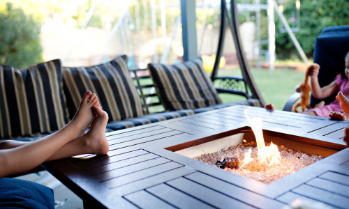 Feet resting on an outdoor fireplace